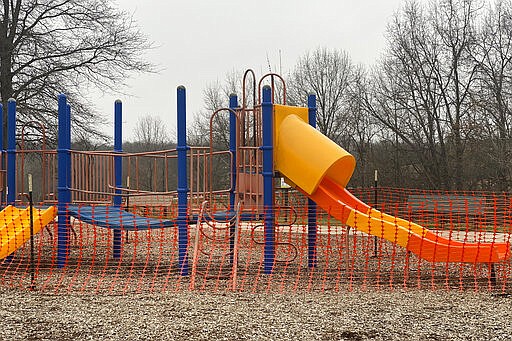 This Tuesday, March 24, 2020, photo provided by the City of Hannibal, Mo., shows Parks and Recreation Department roped off playground equipment at Huckleberry Park. The city is either removing or roping off all playground equipment, and is removing picnic tables from parks  prevent the spread of coronavirus. (Photo by Mary Lynne Richards/The City of Hannibal via AP)