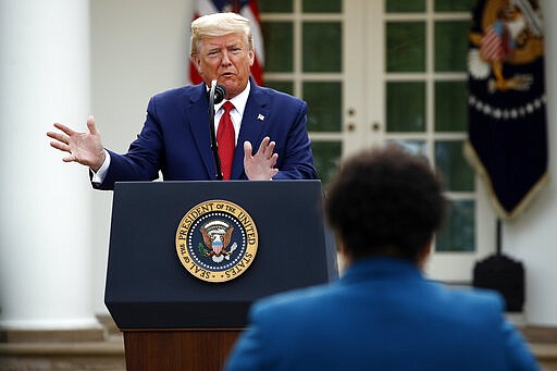 President Donald Trump answers a question from PBS reporter Yamiche Alcindor during a coronavirus task force briefing in the Rose Garden of the White House, Sunday, March 29, 2020, in Washington. (AP Photo/Patrick Semansky)