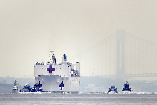 The Navy hospital ship USNS Comfort arrives in New York, Monday, March 30, 2020. The ship has 1,000 beds and 12 operating rooms that could be up and running within 24 hours of its arrival on Monday morning. It's expected to bolster a besieged health care system by treating non-coronavirus patients while hospitals treat people with COVID-19. (AP Photo/Seth Wenig)