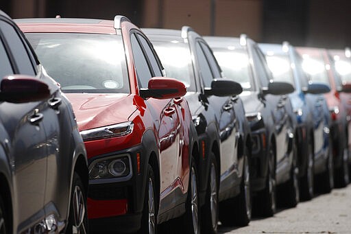 A long row of unsold 2020 Kona sports-utility vehciles sits outside a Hyundai dealership as dealers struggle to entice buyers locked down as a statewide stay-at-home order remains in effect in an effort to reduce the spread of the new coronavirus Monday, March 30, 2020, in Littleton, Colo. The new coronavirus causes mild or moderate symptoms for most people, but for some, especially older adults and people with existing health problems, it can cause more severe illness or death. (AP Photo/David Zalubowski)