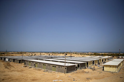 Palestinian workers construct a quarantine complex to be used for coronavirus cases, in the southern Gaza Strip, Monday, March 30, 2020. Fearing a widespread outbreak of the coronavirus, Gaza's Hamas leaders are racing to build two massive quarantine complexes as they try to prepare a territory poorly equipped to deal with a new health crisis (AP Photo/Khalil Hamra)