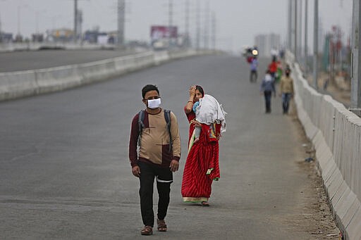 In this Thursday, March 26, 2020, file photo, an Indian couple carrying an infant walk along an expressway hoping to reach their home, hundreds of miles away, as the city comes under lockdown in Ghaziabad, on the outskirts of New Delhi, India. Over the past week, India&#146;s migrant workers - the mainstay of the country&#146;s labor force - spilled out of big cities that have been shuttered due to the coronavirus and returned to their villages, sparking fears that the virus could spread to the countryside. It was an exodus unlike anything seen in India since the 1947 Partition, when British colothe subcontinent, with the 21-day lockdown leaving millions of migrants with no choice but to return to their home villages. (AP Photo/Altaf Qadri, File)