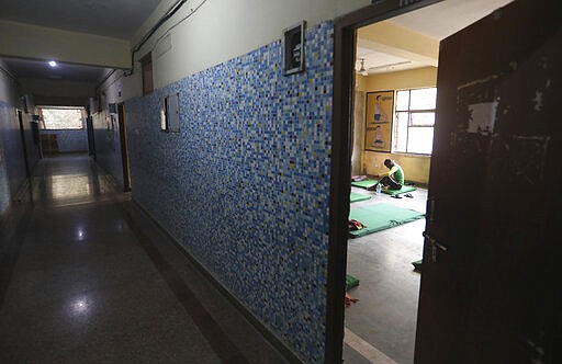 In this Tuesday, March 31, 2020, file photo, a migrant laborers, who was stopped while trying to head back to his hometown and are being quarantined, eats a meal at a government school in New Delhi, India. Over the past week, India&#146;s migrant workers - the mainstay of the country&#146;s labor force - spilled out of big cities that have been shuttered due to the coronavirus and returned to their villages, sparking fears that the virus could spread to the countryside. It was an exodus unlike anything seen in India since the 1947 Partition, when British colothe subcontinent, with the 21-day lockdown leaving millions of migrants with no choice but to return to their home villages. (AP Photo/Manish Swarup, File)