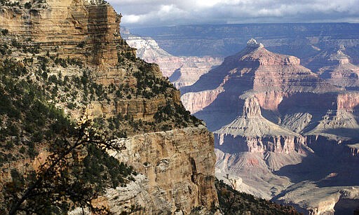 FILE - This Oct. 22, 2012, file photo, shows a view from the South Rim of the Grand Canyon National Park in Ariz. Calls are mounting for the federal government to close Grand Canyon National Park after a resident of the iconic park tested positive for the coronavirus and has been in isolation. Members of Congress and city, county and tribal officials have urged the Interior Department to approve a request from the park to close. The Park Service has been deciding whether to shut down individual sites on a park-by-park basis, in consultation with state and local health officials. Neither the Interior Department nor the Park Service immediately responded to requests Tuesday, March 31, 2020, on the status of the Grand Canyon's request. (AP Photo/Rick Bowmer, File)