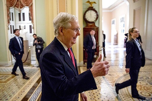 Senate Majority Leader Mitch McConnell of Ky. gives a thumbs up as he arrives on Capitol Hill, Wednesday, March 25, 2020, in Washington. (AP Photo/Andrew Harnik)