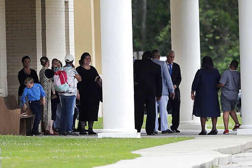 Congregants gather after services at the Life Tabernacle Church in Central, La., Sunday, March 29, 2020. Pastor Tony Spell has defied a shelter-in-place order by Louisiana Gov. John Bel Edwards, due to the new coronavirus pandemic, and continues to hold church services with hundreds of congregants. (AP Photo/Gerald Herbert)