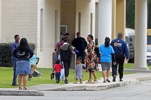 Congregants arrive at the Life Tabernacle Church in Central, La., Sunday, March 29, 2020. Pastor Tony Spell has defied a shelter-in-place order by Louisiana Gov. John Bel Edwards, due to the new coronavirus pandemic, and continues to hold church services with hundreds of congregants. (AP Photo/Gerald Herbert)