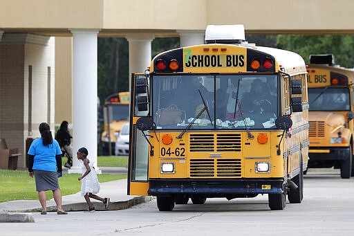 Congregants arrive at the Life Tabernacle Church in Central, La., Sunday, March 29, 2020. Pastor Tony Spell has defied a shelter-in-place order by Louisiana Gov. John Bel Edwards, due to the new coronavirus pandemic, and continues to hold church services with hundreds of congregants. (AP Photo/Gerald Herbert)