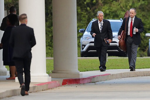 Timothy Spell, second right, father of Pastor Tony Spell, arrives for evening service at the Life Tabernacle Church in Central, La., Tuesday, March 31, 2020. Pastor Spell held services despite being charged with misdemeanors today, for holding services against Gov. John Bel Edwards shelter-in-place order due to the new coronavirus pandemic. (AP Photo/Gerald Herbert)