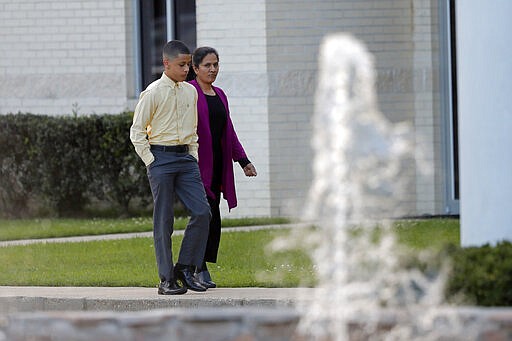 Congregants arrive for evening service at the Life Tabernacle Church in Central, La., Tuesday, March 31, 2020. Pastor Tony Spell held services despite being charged with misdemeanors today, for holding services against Gov. John Bel Edwards shelter-in-place order due to the new coronavirus pandemic. (AP Photo/Gerald Herbert)