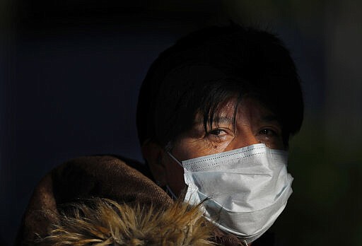 A commuter leaves the Chapultepec subway station wearing a face mask as a precaution amid the spread of the new coronavirus in Mexico City, Friday, March 27, 2020. City authorities announced measures to deal with the new coronavirus such as closing bars, discos, museums, zoos, cinemas, theaters and gyms starting Monday. (AP Photo/Marco Ugarte)