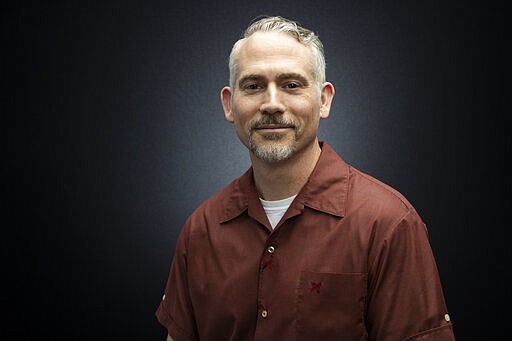 In this March 16, 2020 photo, TV editor and filmmaker Pi Ware poses for a portrait in Los Angeles. Unlike many of his colleagues, Ware is still working. Keeping specifics close to the vest, Ware said he continues to do editing, only now working from his home instead of a studio. (Photo by Willy Sanjuan/Invision/AP)