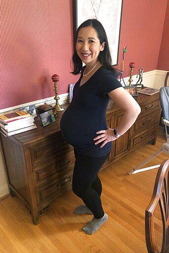 CORRECTS TO GEORGE WASHINGTON UNIVERSITY, NOT GEORGETOWN - In this March 30, 2020 photo, Dr. Leana Wen poses for a photo in her Baltimore home. Wen, a George Washington University public health specialist, who is pregnant and due to give birth soon, says she wants answers as a physician and as a patient to her concerns over the coronavirus. Her greatest fear is developing a COVID-19 infection or symptoms that would force her to be separated from her newborn for days or weeks. I would only be able to see my baby through a glass window. ... Thats the one that gives me nightmares. (Courtesy Dr. Leana Wen via AP)