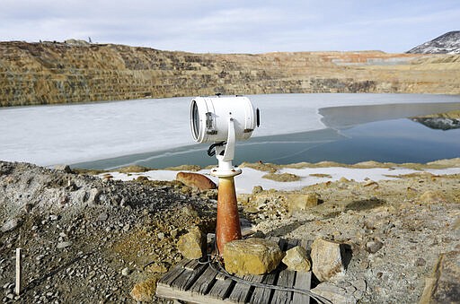 In this March 5, 2020, photo, a spotlight that was once used at a prison is now used to haze migrating birds that might choose to land on the toxic Berkeley Pit water in Butte, Montana. The Trump administration is moving to scale back criminal enforcement of a century-old law protecting most American wild bird species. Mark Thompson, the manager of environmental affairs at Montana Resources, said it would keep up the efforts that drive away almost all birds regardless of the Trump administration&#146;s actions, mirroring pledges from some other companies and industries. (Meagan Thompson/The Montana Standard via AP)