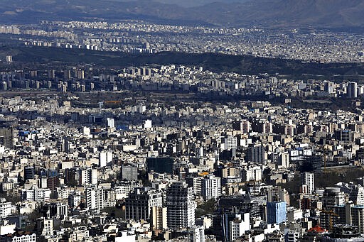 Buildings of the capital Tehran are seen from foothills of the Alborz mountain range, Iran, Tuesday, March 31, 2020. In recent days, Iran which is battling the worst new coronavirus outbreak in the region, has ordered the closure of nonessential businesses and banned intercity travels aimed at preventing the virus' spread.   (AP Photo/Vahid Salemi)