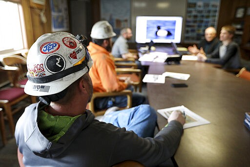 In this March 5, 2020, photo, miners go through a bird identification exercise before they start their shift for Montana Resources in Butte, Montana. The Trump administration is moving to scale back criminal enforcement of a century-old law protecting most American wild bird species. Mark Thompson, the manager of environmental affairs at Montana Resources, said it would keep up the efforts that drive away almost all birds regardless of the Trump administration&#146;s actions, mirroring pledges from some other companies and industries. (Meagan Thompson/The Montana Standard via AP)