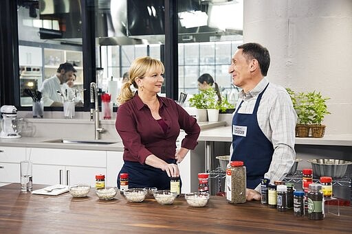 This undated image released by America's Test Kitchen shows host Bridget Lancaster, left, and Chief Creative Officer Jack Bishop from the  series &quot;America's Test Kitchen.&quot; The series is marking its 20th year on PBS and mixing up a new batch of younger viewers who are drawn to the cooking show online. (Kevin White/America's Test Kitchen via AP)