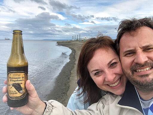 In this March 14, 2020 photo made available by Juan Huergo, he and his wife Laura Gabaroni pose for a photo in Punta Arenas, Chile. The couple were on the cruise vacation to Buenos Aires and Chile when the corona virus pandemic started to spread. They were aboard the Zaandam, a Holland America cruise ship with many experiencing flu-like symptoms. They and others who appear healthy were transferred to the Rotterdam, another Holand America ship. Both cruise ships are headed to Florida. Florida Gov. Ron DeSantis said Monday, March 30, 2020 it would be a mistake to bring passengers to Florida. (Juan Huergo via AP)