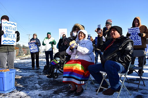 FILE - In this Oct. 29, 2019 file photo, opponents of the Keystone XL oil pipeline from Canada demonstrate in sub-freezing temperatures in Billings, Mont. Alberta is investing $1.1 billion in the disputed Keystone XL pipeline, a project that Alberta Premier Jason Kenney says is crucial for the province's economy. (AP Photo/Matthew Brown, File)