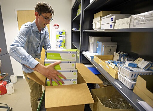 Loyola University professor Dr. CJ Stephenson packs boxes of protective gloves from the Chemistry Department storeroom at Loyola University to donate to the Tulane University School of Medicine in New Orleans, La. Monday, March 30, 2020. Loyola University professors Dr. CJ Stephenson and Dr. Elin Grissom responded to a request by the Tulane University School of Medicine that is asking for public donations of medical protection wear and disposable laboratory supplies. The full list of needed items and the places to donate can be found at medicine.tulane.edu/need-medical-supplies.   (Max Becherer/The Advocate via AP)