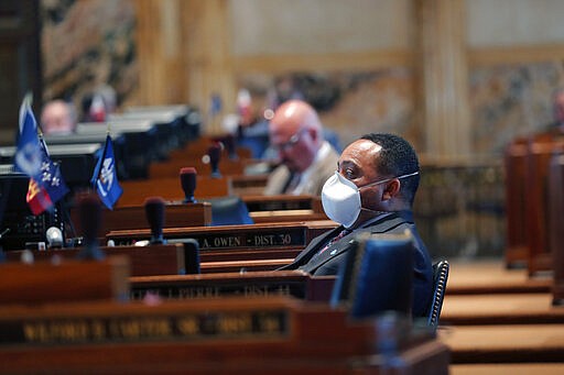 State Rep. Vincent Pierre, D-Dist. 44, wears a mask as legislators convene in a limited number, while exercising social distancing, due to the new coronavirus pandemic, at the State Capitol in Baton Rouge, La., Tuesday, March 31, 2020. They assembled briefly on the last day bills could be introduced during the legislative session. (AP Photo/Gerald Herbert)