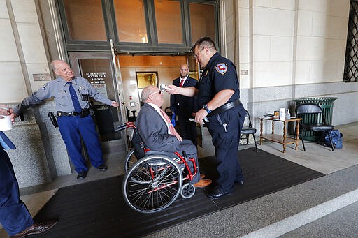 State Rep. R. Dewith Carrier, R-Dist. 32, has his temperature taken as he arrives at the State Capitol in Baton Rouge, La., Tuesday, March 31, 2020. Legislators convened in limited numbers, while exercising social distancing due to the new coronavirus pandemic, on the last day bills could be introduced during the legislative session. (AP Photo/Gerald Herbert)