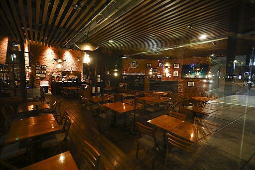 A popular restaurant is absent of customers on Reforma Avenue in Mexico City, Friday, March 27, 2020. City authorities announced measures to deal with the spread of the new coronavirus pandemic such as closing bars, discos, museums, zoos, cinemas, theaters and gyms. (AP Photo / Eduardo Verdugo)