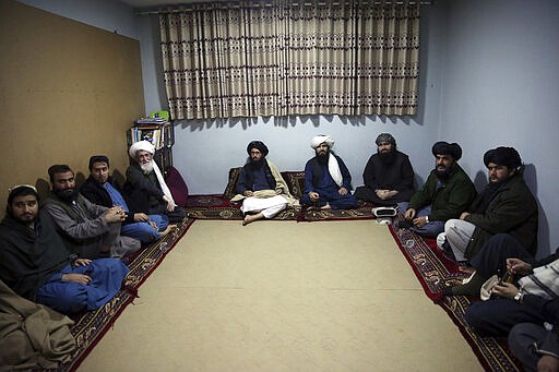 FILE - In this Dec. 14, 2019 file photo, jailed Taliban sit inside the Pul-e-Charkhi Jail after speaking with The Associated Press, in Kabul, Afghanistan. A three-member Taliban technical team arrived Tuesday, March 31, 2020, in the Afghan capital to oversee the release of their prisoners as part of a peace deal signed by the Taliban and the U.S., a spokesman for the insurgent group said. (AP Photo/Rahmat Gul, File)