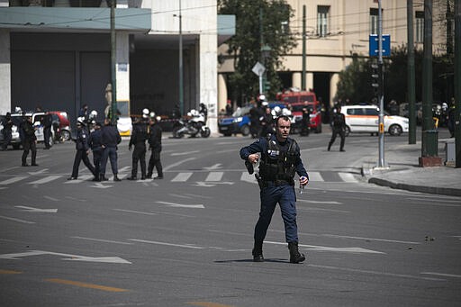 Police block the Athens' main Syntagma square during an operation on Tuesday, March 31, 2020. Police in Greece have cordoned off an area near the country's parliament after workers found what is believed to be a decades-old mortar shell during maintenance on the water mains. (AP Photo/Yorgos Karahalis)