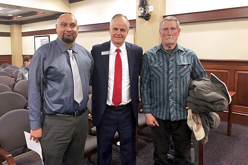 FILE - In this Feb. 11, 2020, file photo, from left, Christopher Tapp, Republican Rep. Doug Ricks and Charles Fain appeared before the Idaho House Judiciary, Rules and Administration Committee in Boise, Idaho, to testify in favor of legislation that would compensate the wrongly convicted. Tapp and Fain combined spent nearly 40 years in Idaho prisons for crimes they didn't commit after being convicted of murder. Idaho Gov. Brad Little has vetoed legislation that would have set up a process to compensate people convicted of crimes they didn't commit. The Republican governor in his veto message on Monday, March 31, 2020, says the measure's objective is admirable, but its process using the courts is flawed. (AP Photo/Keith Ridler, File)