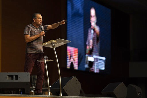 Pastor Silas Malafaia delivers a sermon during a service transmitted on live through social networks, at the empty Assembly of God Victory in Christ Church in reason to the restrictions for agglomerations due the new coronavirus, in Rio de Janeiro, Brazil, Sunday, March 29, 2020. Brazil's President Jair Bolsonaro, a conservative Catholic who married an evangelical in a service Malafaia administered, has zeroed in on the need to reopen the churches. &#147;God is Brazilian,&#148; he told people on Sunday, local paper O Globo reported. (AP Photo/Leo Correa)