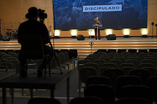 Pastor Silas Malafaia delivers a sermon transmitted live through social networks, from inside the empty Assembly of God Victory in Christ Church, amid a lockdown to help contain the spread of the new coronavirus in Rio de Janeiro, Brazil, Sunday, March 29, 2020. Malafaia and other evangelical leaders across Brazil have voiced outrage at governors&#146; decisions that all non-essential businesses and gathering such as churches, shut down, warning they would only cooperate under court order. (AP Photo/Leo Correa)