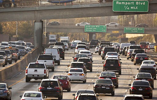 FILE - This Dec. 12, 2018, file photo shows traffic on the Hollywood Freeway in Los Angeles. The Trump administration is rolling back tough Obama-era mileage standards and gutting one of the United States' biggest efforts to slow climate change. The administration released its relaxed mileage rules Tuesday. (AP Photo/Damian Dovarganes, File)