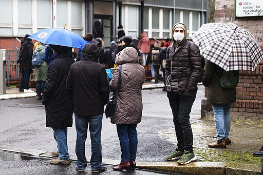 FILE - In this March 9, 2020, file photo, people line up in front of a new set up test and information center for the new coronavirus at the district Prenzlauer Berg in Berlin, Germany. Germany has seen a steady rise in the number of new coronavirus infections, but so far deaths have been low compared to many of its European neighbors. (AP Photo/Markus Schreiber, File)