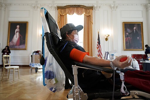 Sugin Quang donates at a blood drive hosted by the Richard Nixon Presidential Library to help meet the urgent demand for donations amid the Coronavirus outbreak across the United States in Yorba Linda, Calif., Tuesday, March 31, 2020. (AP Photo/Chris Carlson)