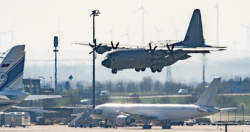 FILE - In this March 25, 2020, file photo, an Italian Air Force plane carrying two patients from Italy believed to have COVID-19, lands at Leipzig Airport, Germany. In the rare position of having beds to spare, German hospitals have taken in dozens of patients from Italy and France. (Hendrik Schmidt/dpa via AP, File)