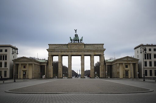 FILE - In this March 30, 2020, file photo, the Pariser Platz square in front of the German landmark Brandenburg Gate is deserted in Berlin, Germany. Labs were quick to ramp up their testing capacity and now experts say up to 500,000 tests can be conducted in Germany per week. That quick work, coupled with the country's large number of intensive care unit beds and its early implementation of social distancing measures, could be behind Germany's relatively low death toll. (AP Photo/Markus Schreiber, File)