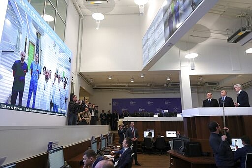 In this photo taken on Tuesday, March 17, 2020, Russian President Vladimir Putin, second right, Prime Minister Mikhail Mishustin, third right, and Moscow Mayor Sergei Sobyanin, right, visit a call center of the emergency response center on control and monitoring of the coronavirus disease, in Moscow, Russia. Russian authorities declared a war on &quot;fake news&quot; related to the new coronavirus. The crusade was triggered by what looked like a real disinformation campaign, but as the outbreak in Russia picked up speed and criticism of the Kremlin's &quot;it is under control&quot; stance mounted, the authorities cracked down on social media users doubting the official numbers and news outlets questioning the government's response to the epidemic. (Mikhail Klimentyev, Sputnik, Kremlin Pool Photo via AP)