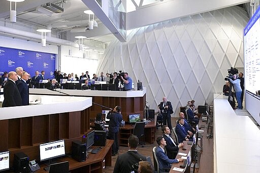 In this photo taken on Tuesday, March 17, 2020, Russian President Vladimir Putin, third left, Prime Minister Mikhail Mishustin, left, and Moscow Mayor Sergei Sobyanin visit a call center of the emergency response center on control and monitoring of the coronavirus disease, in Moscow, Russia. Russian authorities declared a war on &quot;fake news&quot; related to the new coronavirus. The crusade was triggered by what looked like a real disinformation campaign, but as the outbreak in Russia picked up speed and criticism of the Kremlin's &quot;it is under control&quot; stance mounted, the authorities cracked down on social media users doubting the official numbers and news outlets questioning the government's response to the epidemic.(Alexander Astafyev, Sputnik, Kremlin Pool Photo via AP)