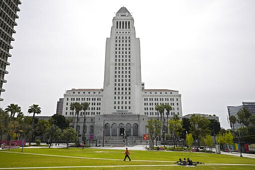 A few people use Grand Park at the foot of Los Angeles City Hall, Tuesday, March 31, 2020, in Los Angeles. The new coronavirus causes mild or moderate symptoms for most people, but for some, especially older adults and people with existing health problems, it can cause more severe illness or death. (AP Photo/Mark J. Terrill)