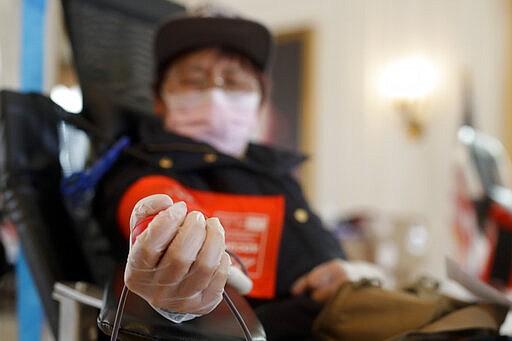 Sugin Quang donates at a blood drive hosted by the Richard Nixon Presidential Library to help meet the urgent demand for donations amid the Coronavirus outbreak across the United States in Yorba Linda, Calif., Tuesday, March 31, 2020. (AP Photo/Chris Carlson)