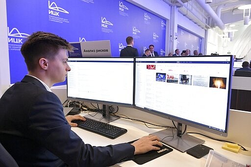 In this photo taken on Tuesday, March 17, 2020, An employee of a call center of the emergency response center on control and monitoring of the coronavirus disease, in Moscow, Russia. Russian authorities declared a war on &quot;fake news&quot; related to the new coronavirus. The crusade was triggered by what looked like a real disinformation campaign, but as the outbreak in Russia picked up speed and criticism of the Kremlin's &quot;it is under control&quot; stance mounted, the authorities cracked down on social media users doubting the official numbers and news outlets questioning the government's response to the epidemic. (Alexander Astafyev, Sputnik, Kremlin Pool Photo via AP)