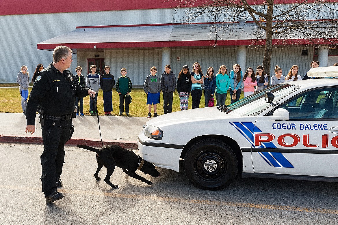 SHAWN GUST/Press 

Spirit Lake Chief Keith Hutcheson points out the changes in behavior of Shade during a demonstration of a search at Canfield Middle School on Friday.