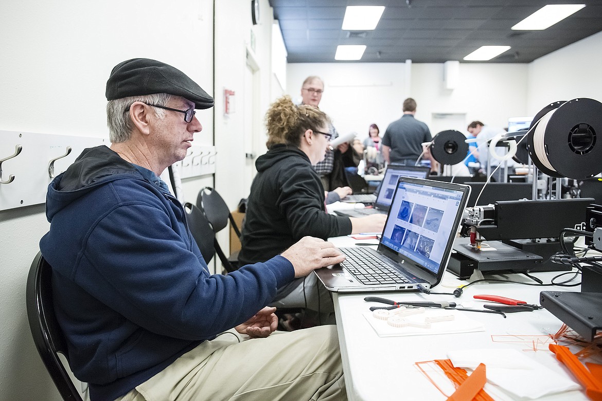 &#151;Photo courtesy OTTO KITSINGER
Martin Jones and Stefani Hoffman, teachers at Clark Fork Junior/Senior High School and Plummer&#146;s Lakeside Junior/Senior High School, respectively, work on 3D printing projects at a recent Idaho STEM Action Center workshop at the Discovery Center of Idaho. They were among 20 teachers from 15 schools throughout the Gem State that the Digital Harbor Foundation trained and the STEM Action Center equipped to assemble and coach teams to vie in the Idaho FabSLAM competition. 3D printers work somewhat like ordinary printers, but instead of laying ink onto paper they extrude thin layers of molten plastic that are built up to make solid, useful three-dimensional objects of virtually any shape.