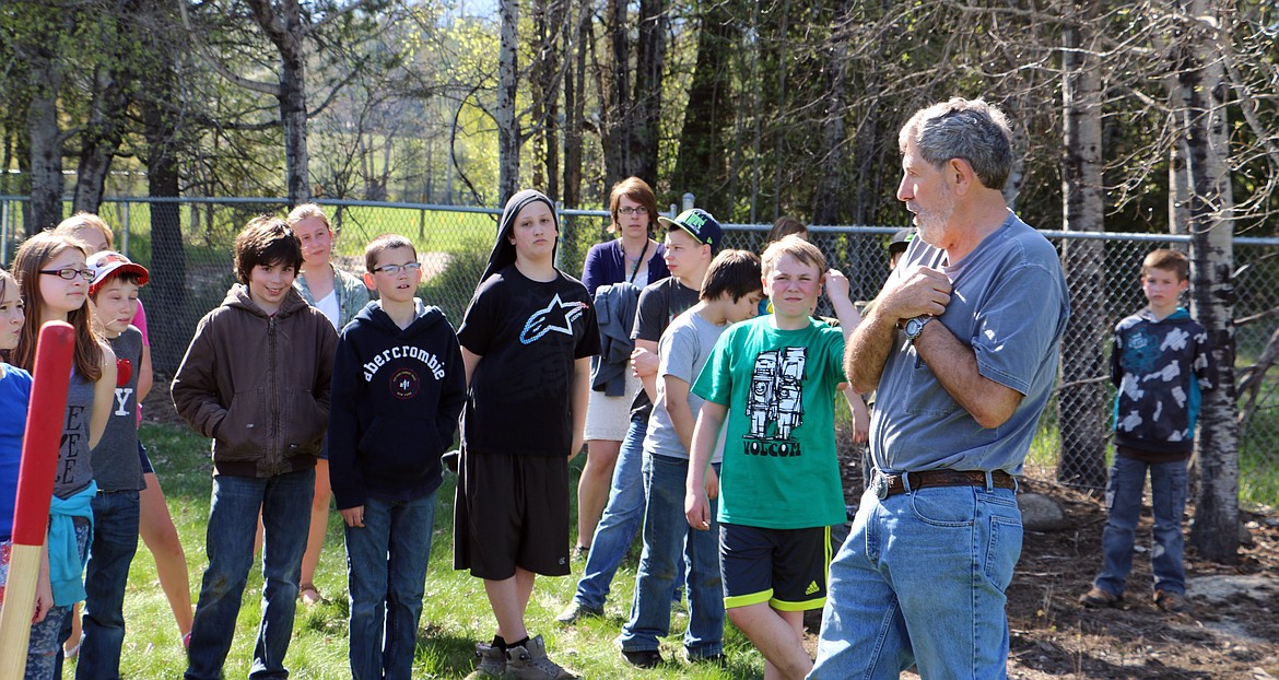 -- Photo by LYNNE HALEY

Sagle sixth-graders gather around Gray Henderson, foreground, as he briefs them on the garden project.