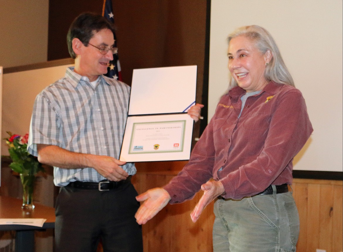 &#151;Photo by LYNNE HALEY
Katherine Cousins, right, a biologist with the Idaho Department of Fish and Game, receives the Army Corps of Engineers Partnership Award for her work at Clark Fork delta.