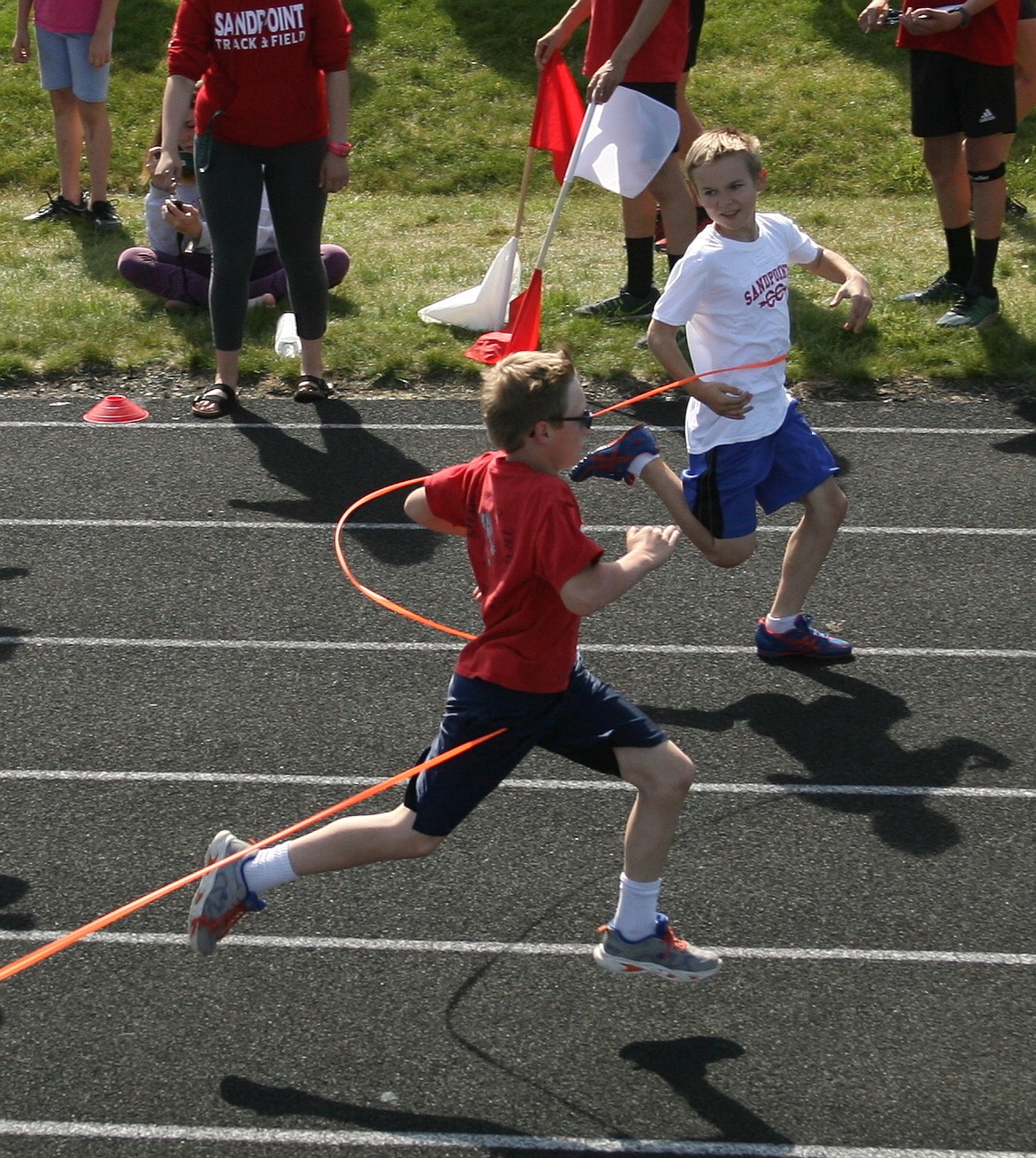 Two racers break the tape at the same time on Friday at the youth Community Track Meet at Sandpoint High School. The meet is run by the SHS track and cross country teams, giving area youth a chance at the thrill of fun competition in races, the broad jump and the softball throw. See the Bee next week for the results.
&#151;Photo by ERIC PLUMMER