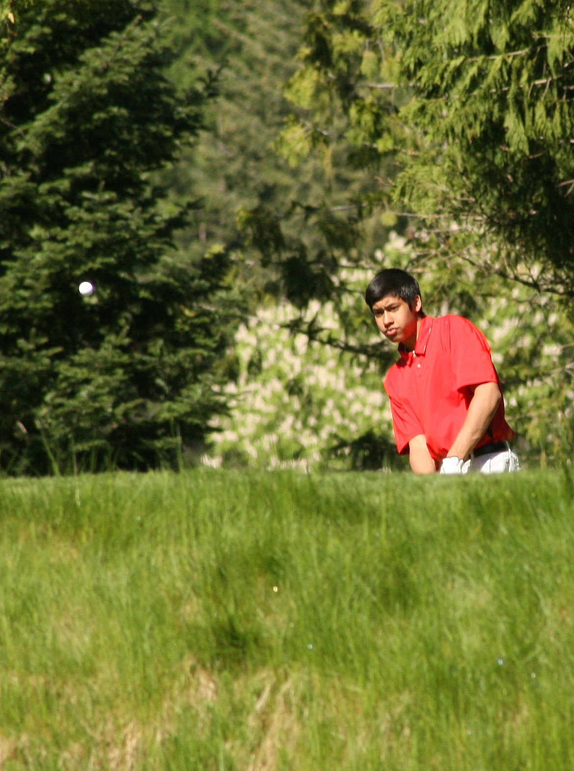 &#151;Photo by ERIC PLUMMER
Sandpoint golfer Jacob Humrich chips onto the green on Tuesday during the Sandpoint Invitational at the Idaho Club.