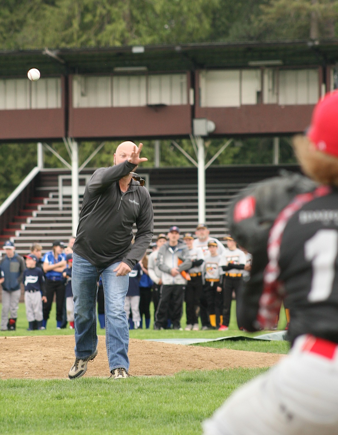 Mike Henley, Plant Manager of Idaho Forest Group&#146;s Chilco and Laclede plants, throws out the ceremonial first pitch recently during the Sandpoint Little League Opening Day ceremonies at War Memorial Field. Henley was chosen for the honor as a show of thanks for Idaho Forest Group&#146;s ever-present support and sponsorship of little league baseball. Before the first pitch, in front of several hundred players and parents on hand, Sandpoint Little League president Tony Butler thanked Henley and IFG, as well as every local business that supports one of the most time-honored traditions in America in Little League baseball. 

&#151;Photo by ERIC PLUMMER