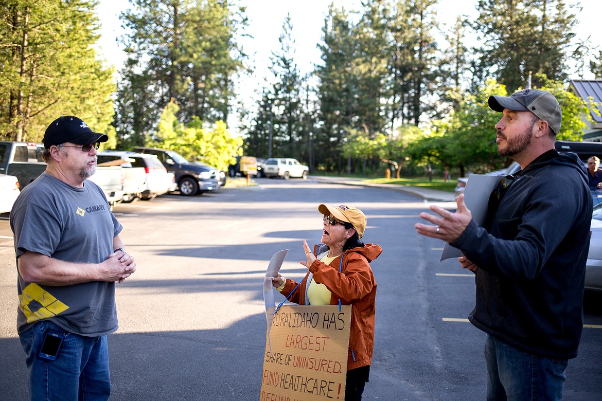 JAKE PARRISH/Press

Leland Olson, left, expresses his pro-wolf-control opinion on Monday to anti-control protestors Cecilia Nothenius and Jamison Johnson outside the Idaho Department of Fish and Game.